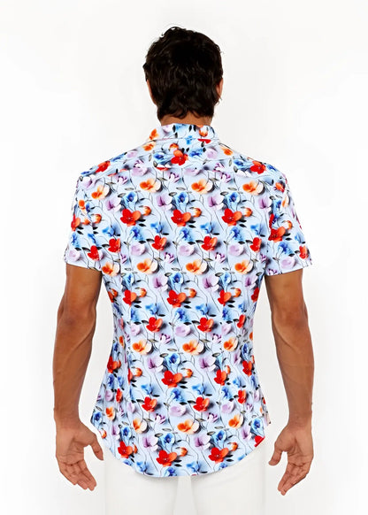 A vibrant floral 3d print stretch knit short-sleeved men’s shirt with red orange blue and purple blossoms on light blue
