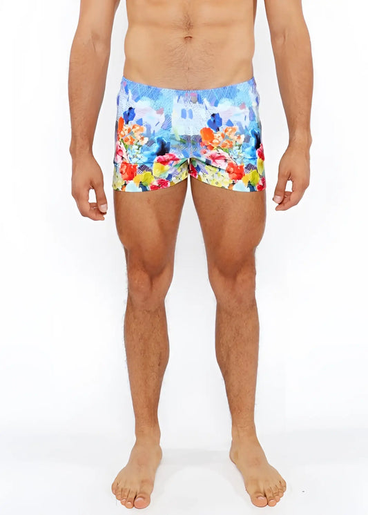 Floral abstract printed swim shorts with vibrant multicolored floral and castle print in blue red yellow and orange