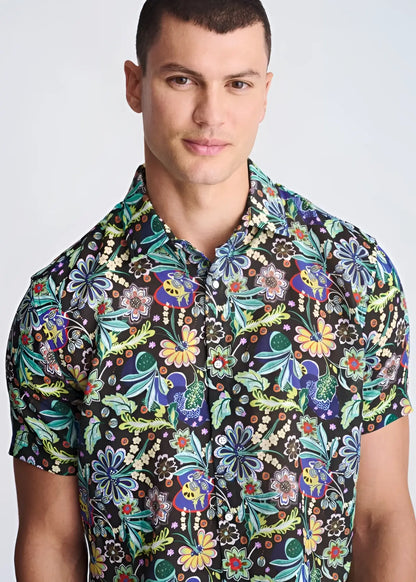 A vibrant floral lightweight linen tencel short-sleeved shirt with green blue yellow and purple pattern on dark background