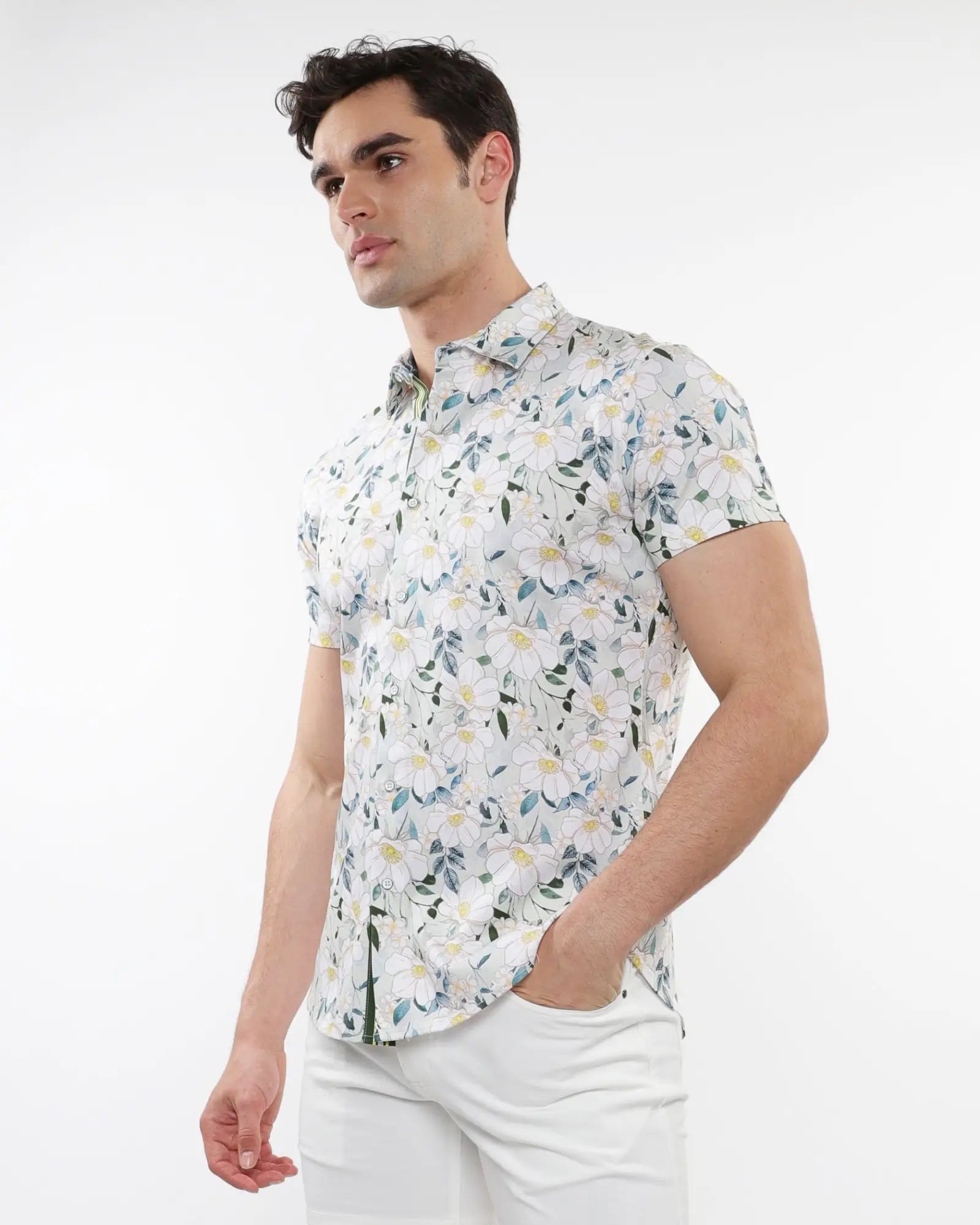White short-sleeved stretch knit shirt with delicate green and yellow floral print pattern