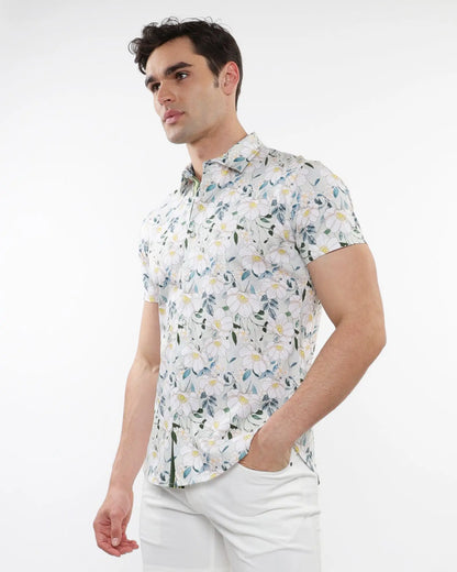White short-sleeved stretch knit shirt with delicate green and yellow floral print pattern