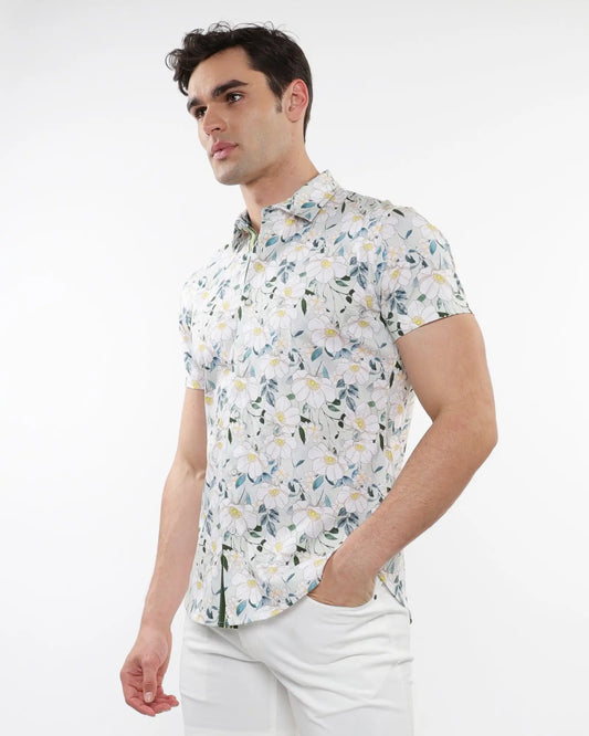 White short-sleeved stretch knit shirt with delicate green and yellow floral print pattern