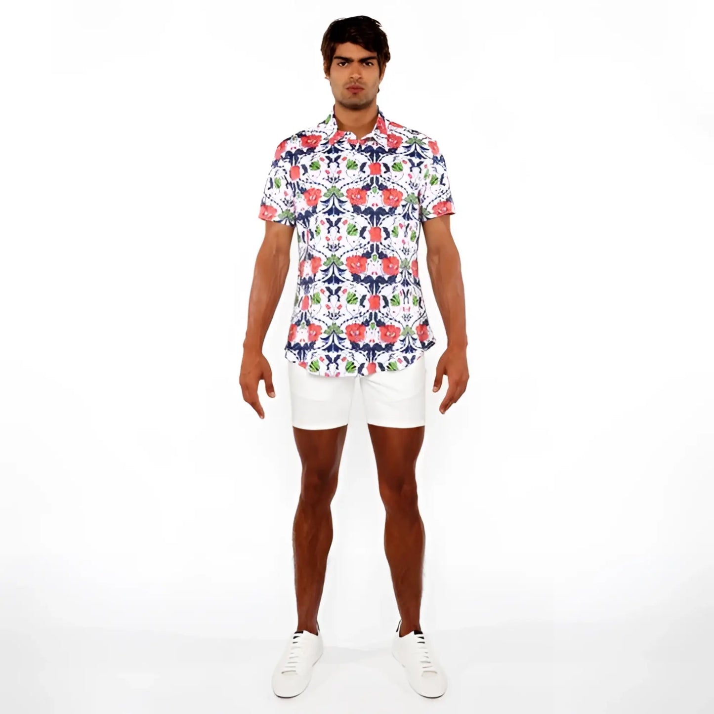 A man wearing a floral print stretch knit shirt with red blue and green flowers on white short-sleeved button-up shirt