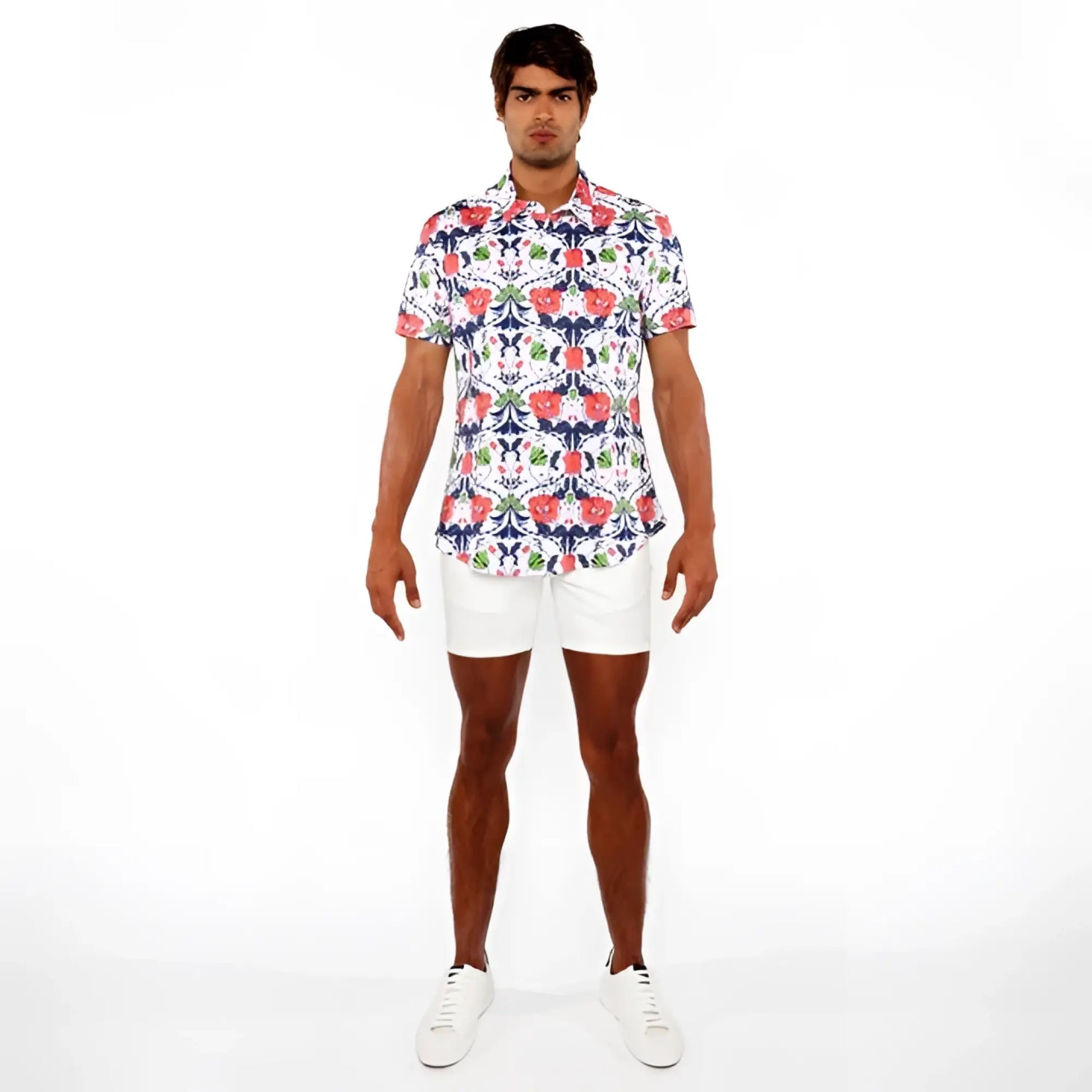 A man wearing a floral print stretch knit shirt with red blue and green flowers on white short-sleeved button-up shirt