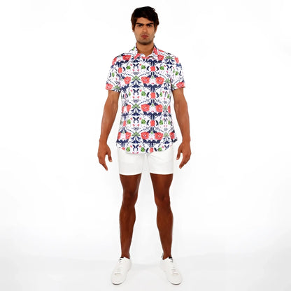 A man wearing a floral print stretch knit shirt with red blue and green flowers on white short-sleeved button-up shirt
