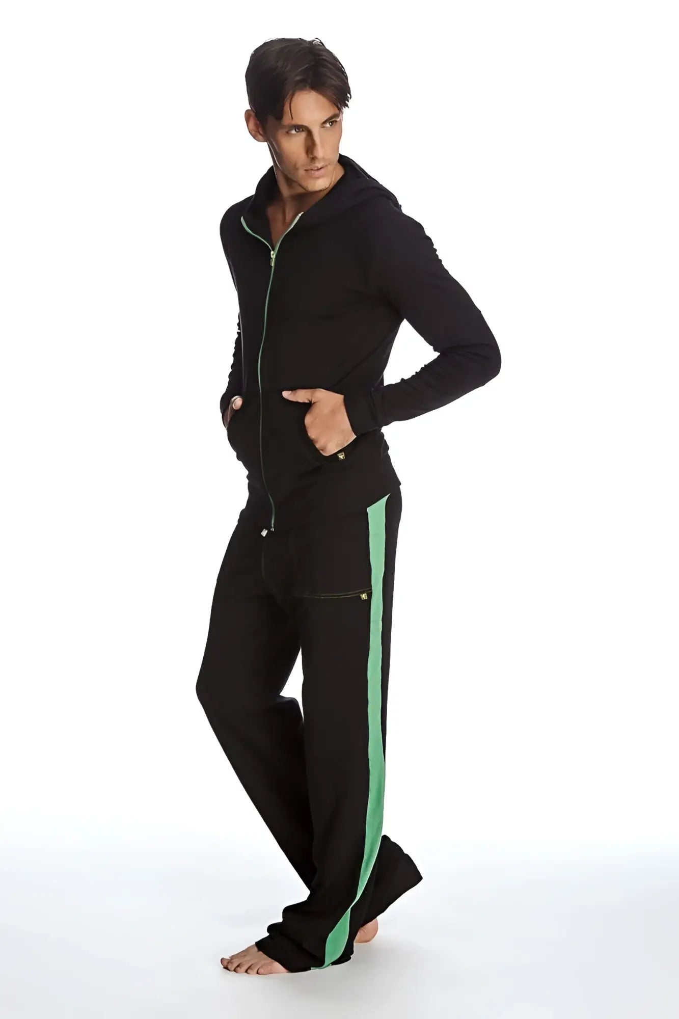 Form-fit crossover yoga track performance hoodie set in black with green zipper and matching pants with green stripe