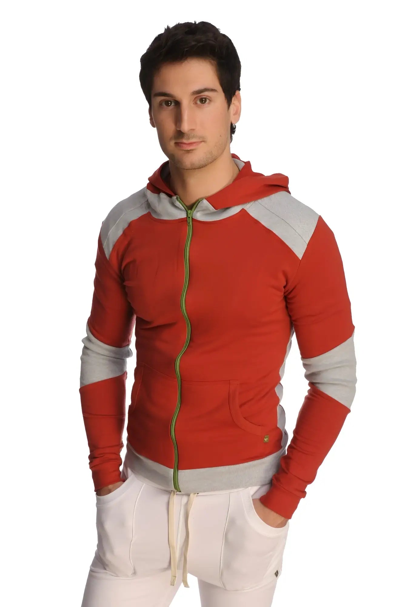 Form-fit crossover yoga track performance hoodie in cinnabar grey with red and gray panels, green zipper pull, and front pockets