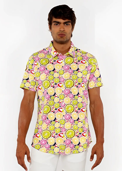 A vibrant fruits print stretch knit short-sleeved polo shirt with lime and pink citrus slices on light yellow background
