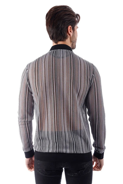 A man wearing a funky novelty bomber jacket with black and white striped sheer patterned fabric long sleeves