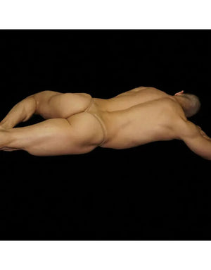 Arroyman nude Y-string thong worn by a model lying down seen from behind against a black background