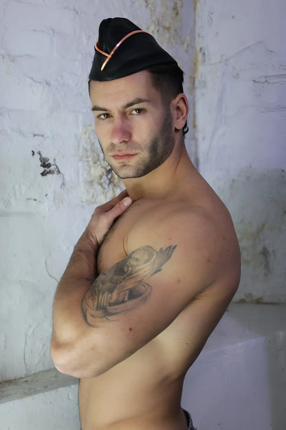 Black military-style garrison hat with orange trim made of durable fabric for formal and ceremonial use