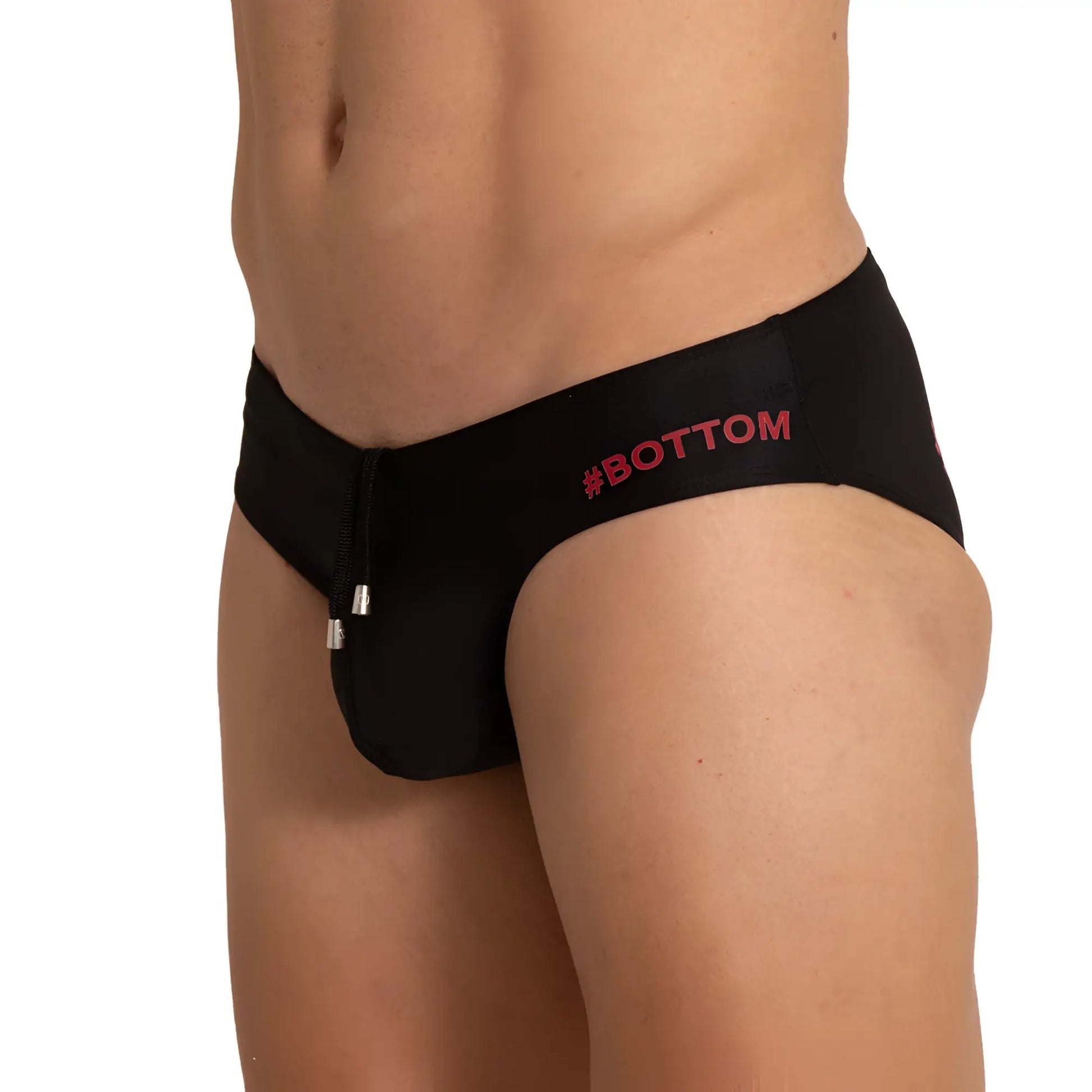 Black menâ€™s swim briefs with red bottom logo and silver zipper pull in gigo bottom black swim brief design