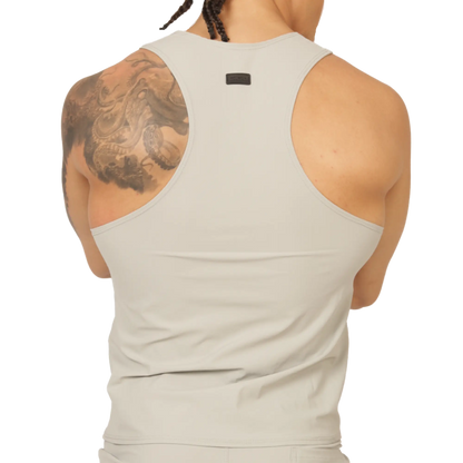 A sleek off-white racerback tank top with minimalist design and small black gigo club brand tag at the neckline