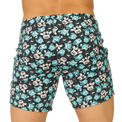Black swim trunks by gigo comics beachwear with turquoise and white cartoon monster pattern for beach use