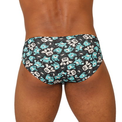 Black gigo comics swimbrief swim trunks with playful turquoise and white cartoon shark pattern for beachwear