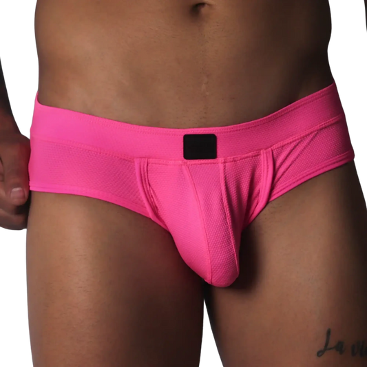 Fuchsia-colored low-rise briefs in textured mesh fabric with a centered black logo patch on the waistband.