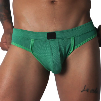 Green jockstrap featuring a textured honeycomb fabric, wide waistband, and a solid black central logo patch.