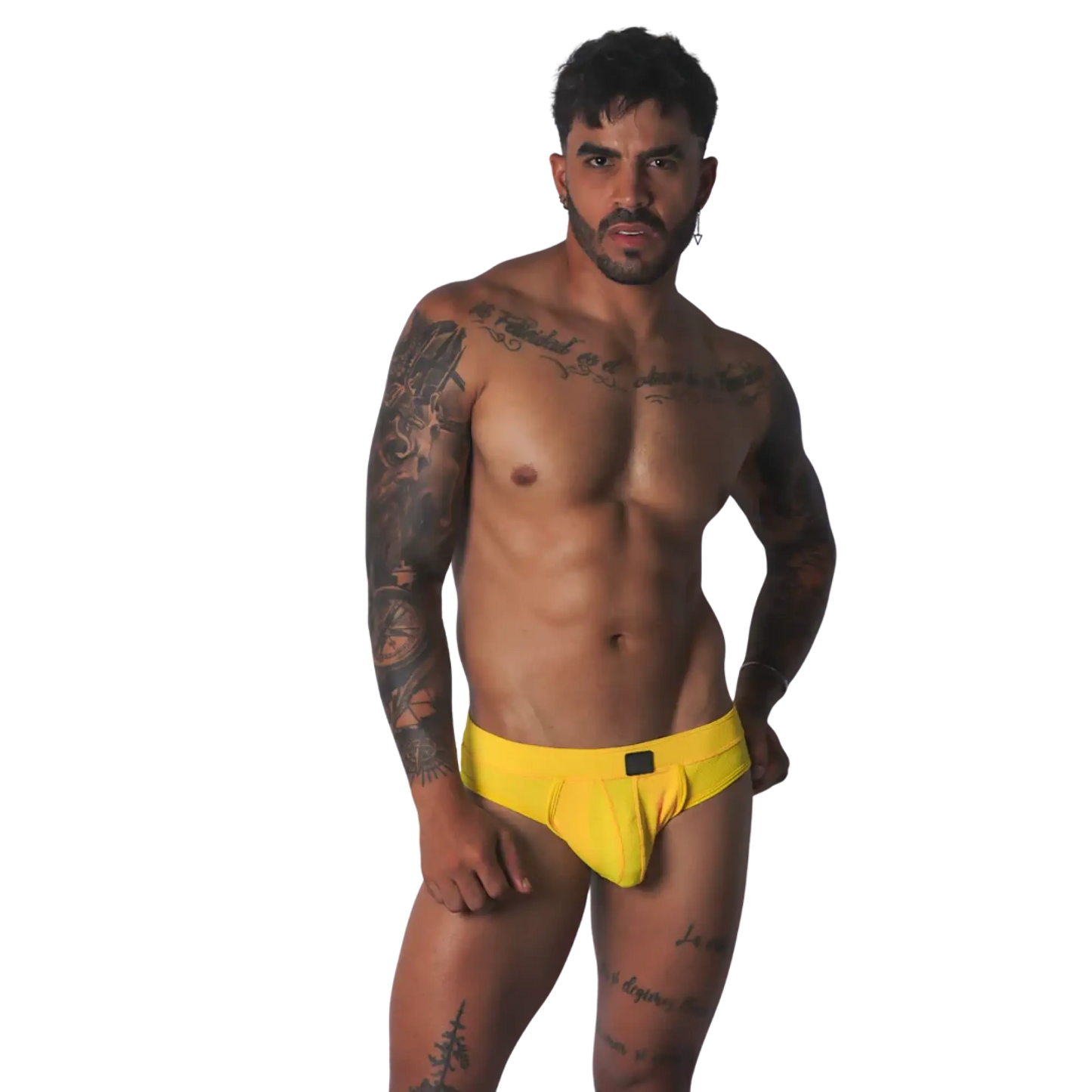 Yellow textured fabric jockstrap with a central black tab detail on the waistband, worn by a tattooed man.