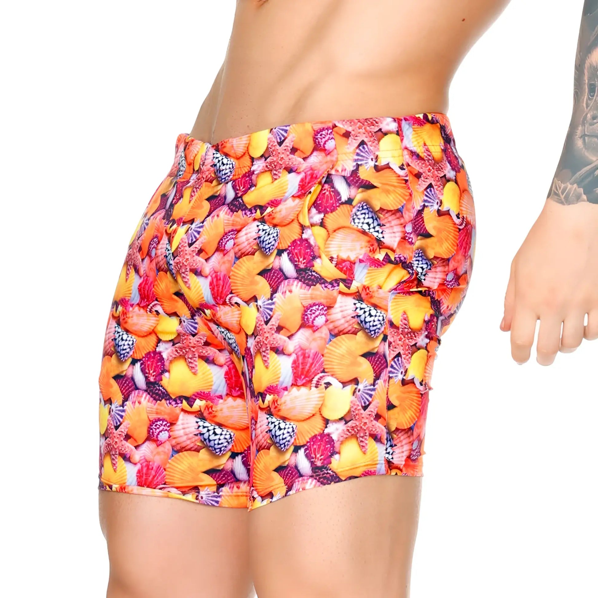 Vibrant gigo corals beachwear high-waisted swim trunks with bold seashell and starfish print in orange pink yellow and purple