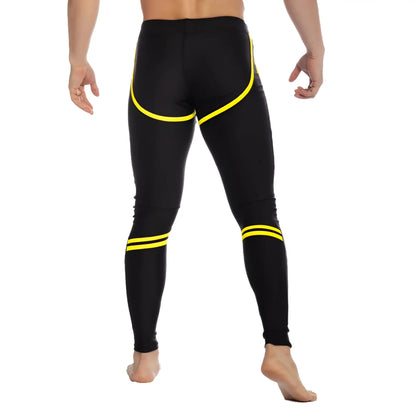 Black gigo core leggings with bold yellow accent stripes along sides and ankles for athletic wear