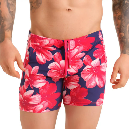 Gigo Flowers fuchsia beachwear vibrant pink and white hibiscus swim trunks with navy fabric and matching drawstring waistband