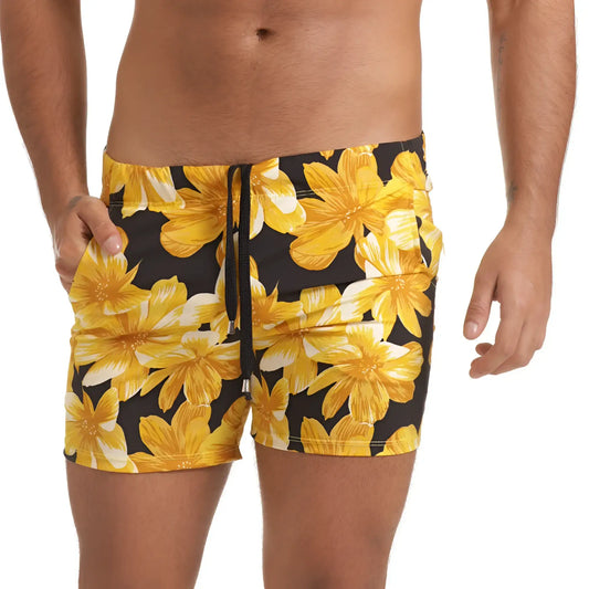 Black swim trunks with vibrant yellow and white floral pattern and drawstring waistband from Gigo Flowers Yellow Beachwear