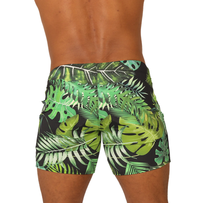 Black swim trunks from gigo forest beachwear with vibrant green and white tropical leaf pattern for beach use