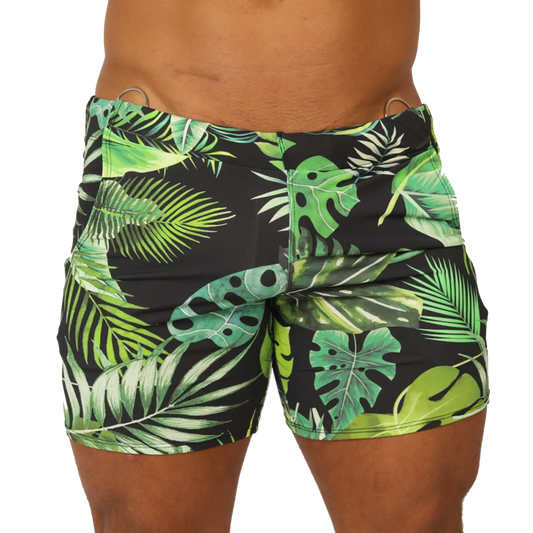 Black swim trunks with vibrant green and lime tropical leaf pattern and metallic silver waistband rings by Gigo Forest