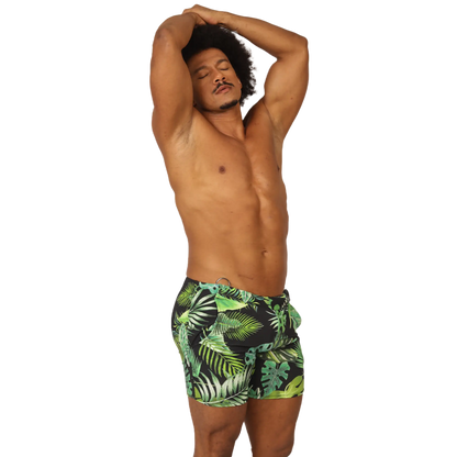 Menâ€™s black swim trunks with vibrant green and lime tropical leaf pattern from Gigo Forest Beachwear