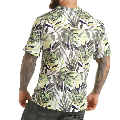 A menâ€™s short-sleeved button-up gigo jungle shirt with vibrant green gray and navy tropical leaf pattern on white background