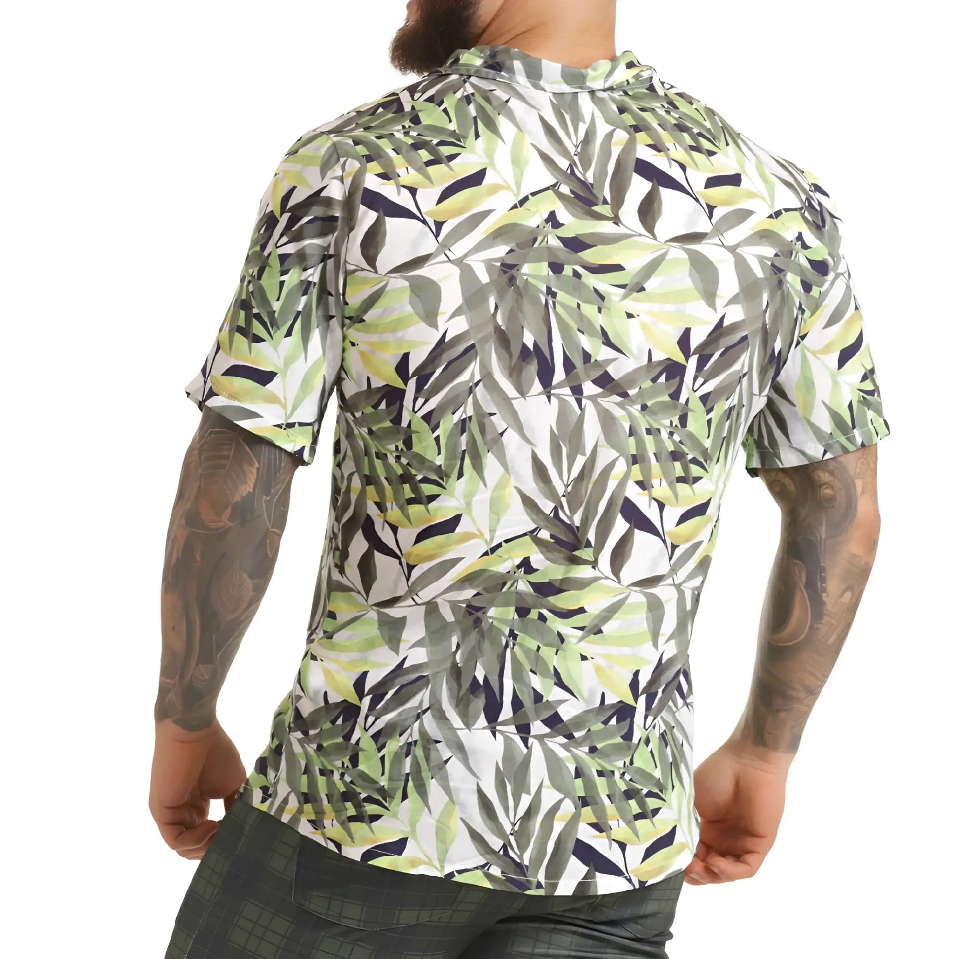 A menâ€™s short-sleeved button-up gigo jungle shirt with vibrant green gray and navy tropical leaf pattern on white background