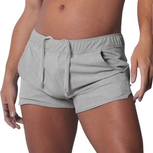 Gray mid-thigh athletic shorts with an elastic drawstring waistband and curved hem side slits.