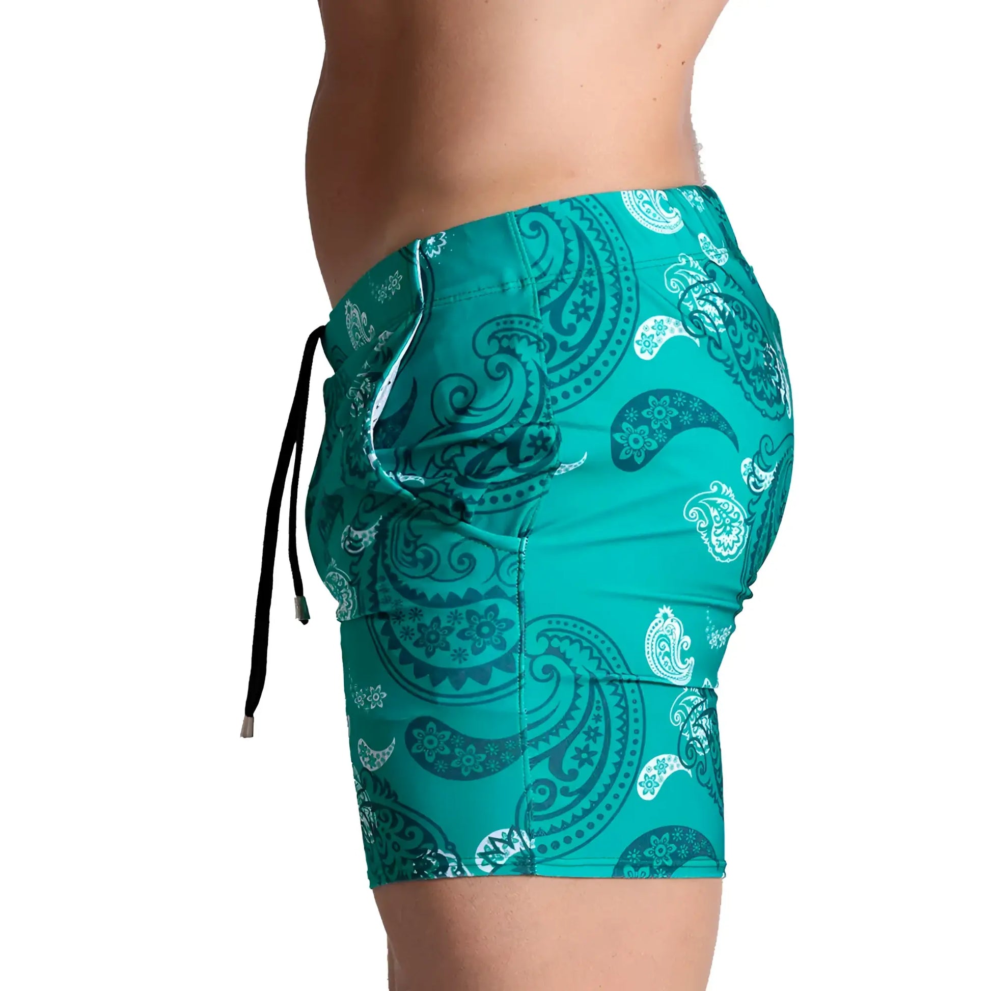 Gigo Paradise Beachwear teal swim trunks with bold white and dark teal paisley pattern and black adjustable drawstrings