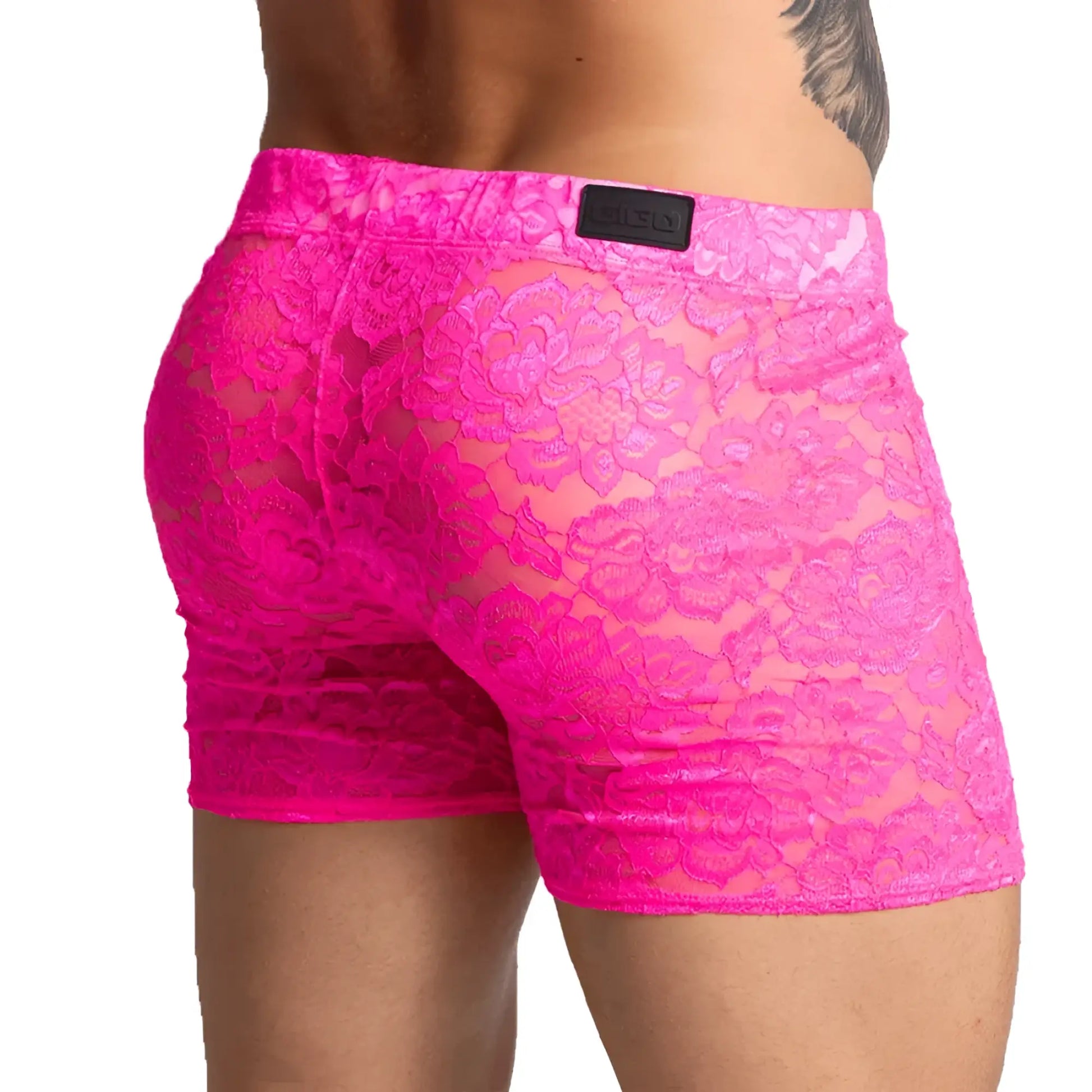 Bright pink lace menâ€™s shorts with a floral pattern and black brand patch on the waistband from Gigo Paradise