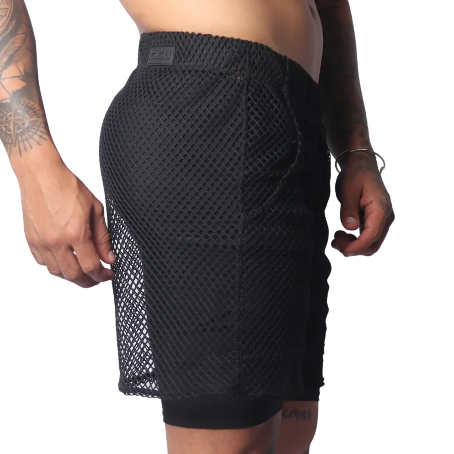 Black athletic shorts in a large-grid fishnet material with a solid inner layer and a branded elastic waistband.