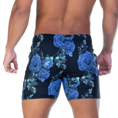 Black swim trunks with vibrant blue rose and leaf pattern from gigo rose blue beachwear for beach use