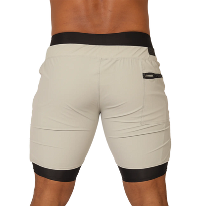 Beige gigo sporty gray short with black elastic waistband and leg cuffs featuring a side zip pocket for activewear