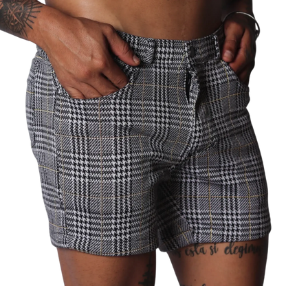 Men's slim-fit shorts in a black and white houndstooth glen plaid pattern with subtle gold thread accents.