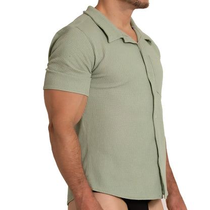 A menâ€™s short-sleeved polo shirt in muted sage green with textured waffle knit and classic collar gigo tissue green shirt