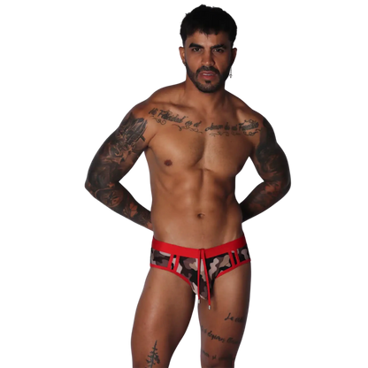 Men's low-rise swim brief in camo print with red waistband, cutouts, and a front drawstring tie.