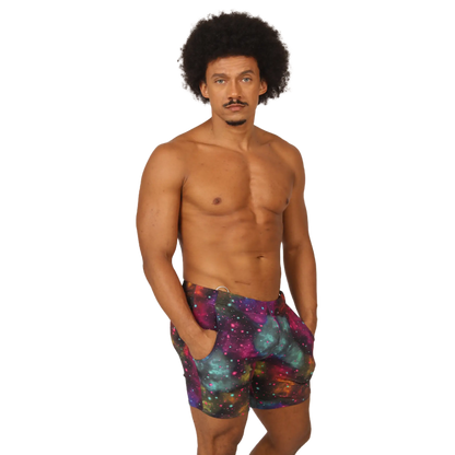 Menâ€™s galaxy-print swim trunks in purple teal and pink cosmic nebula design from Gigo Universe Beachwear