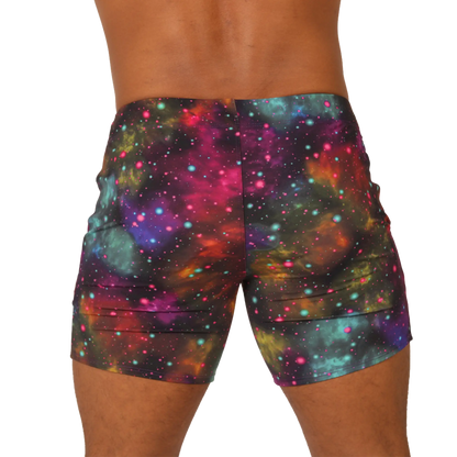 Vibrant gigo universe beachwear galaxy-print shorts with pink purple teal and orange nebulae and sparkling stars