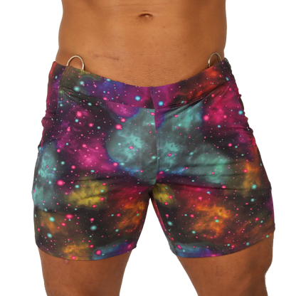 Vibrant Gigo Universe beachwear galaxy-print swim trunks with swirling nebulae in purple teal pink and orange