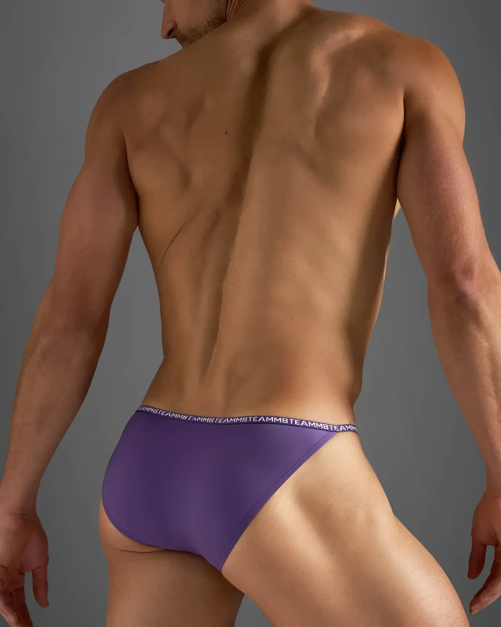 Purple glide micro brief athletic briefs with white repeating logo waistband band designed for active wear