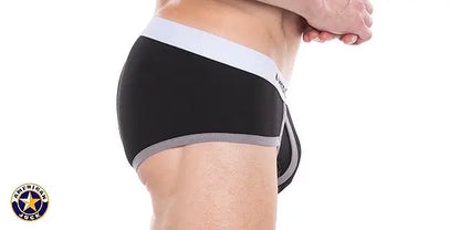 Men's black classic brief with a white waistband and gray trim shown on a model from the side by AMERICAN JOCK
