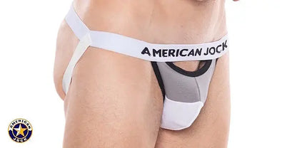 Men's jockstrap in platinum with a gray pouch and white waistband featuring 'AMERICAN JOCK' logo shown on a model