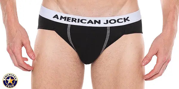 Black bikini underwear with a white waistband featuring 'AMERICAN JOCK' logo shown on a model from the front