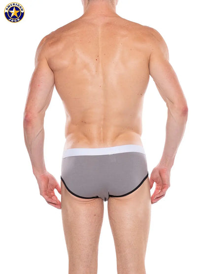 Men's gray core brief with a white waistband shown from the back on a model by AMERICAN JOCK