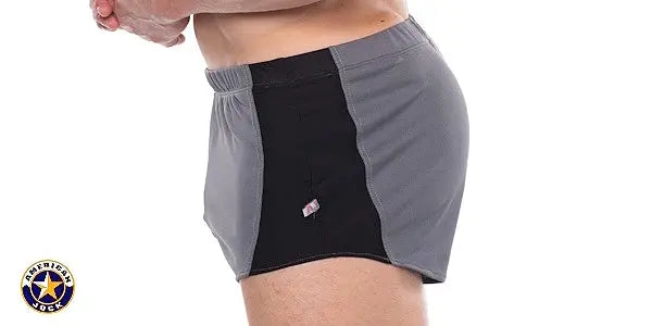 Men's sprint shorts in platinum and black featuring a comfortable elastic waistband shown on a model from the side by AMERICAN JOCK