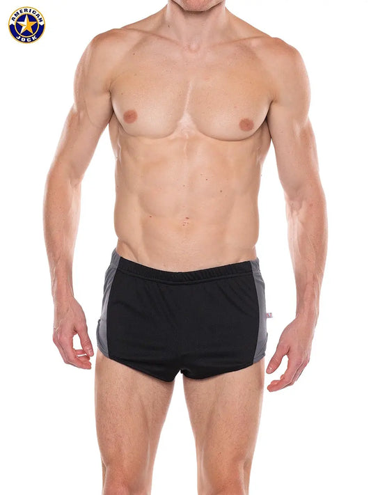 Men's black sprint shorts with gray side panels featuring an elastic waistband worn by a model. By AMERICAN JOCK